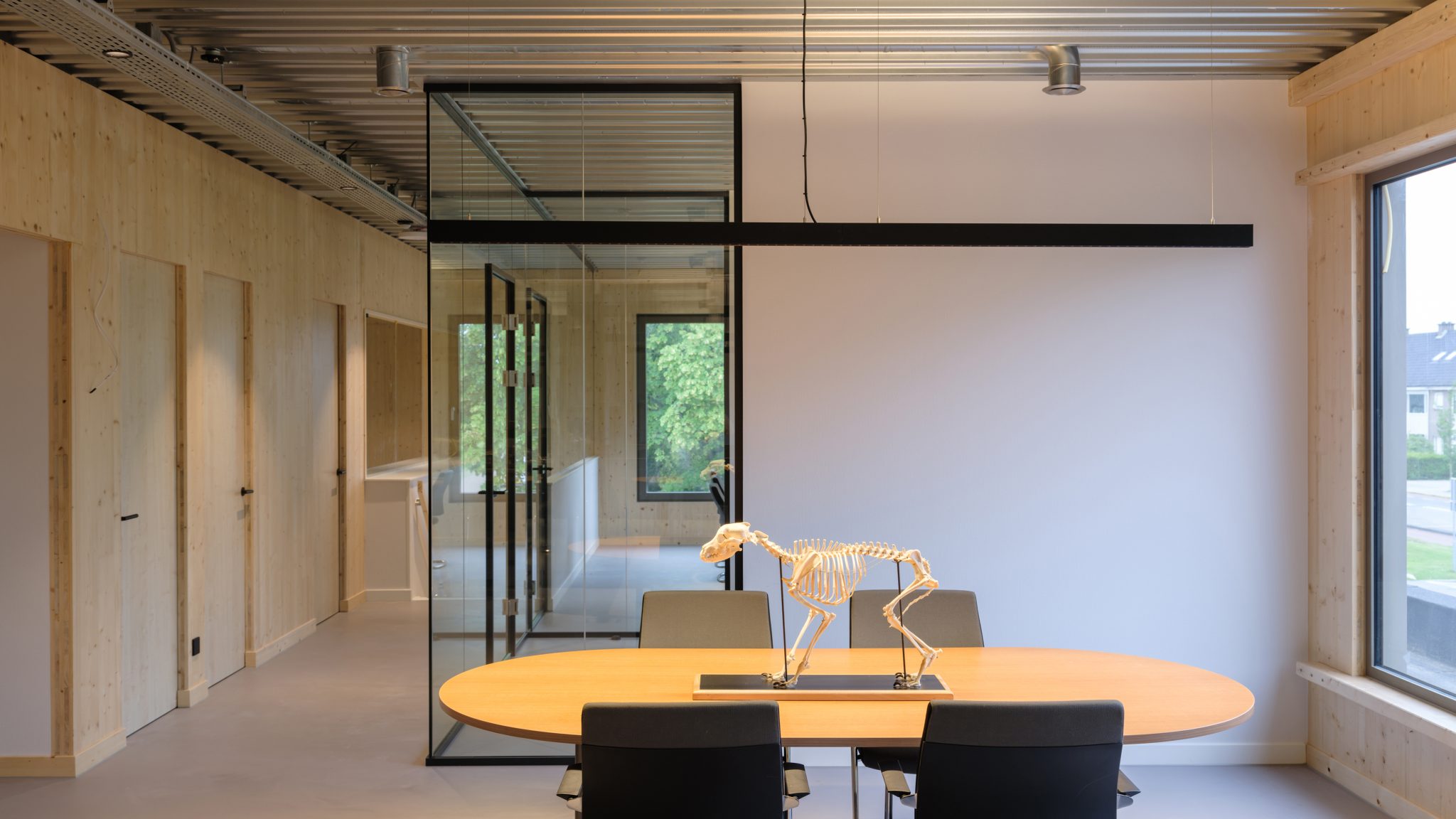 Meeting room CLT wood black table_wooden wall_galvanized steel_big windows_by MOST Architecture