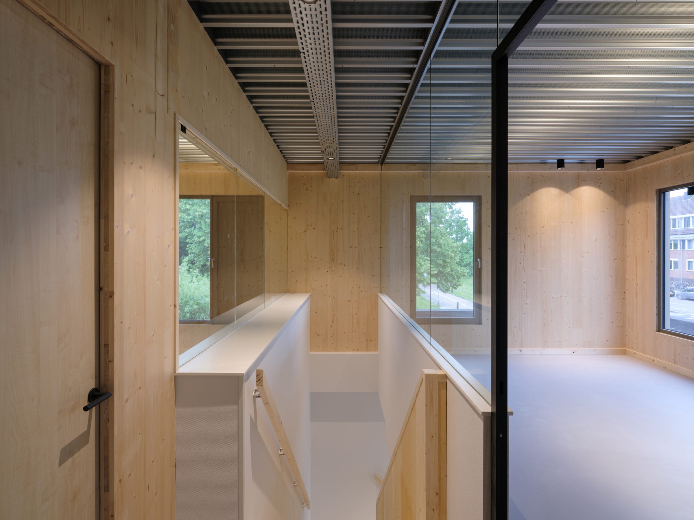 Interior view of CLT extension of Anicura Dierenkliniek Leidse Land Leiderdorp with galvanized steel ceiling and CLT wall define wooden atmosphere interior design by MOST Architecture Rotterdam