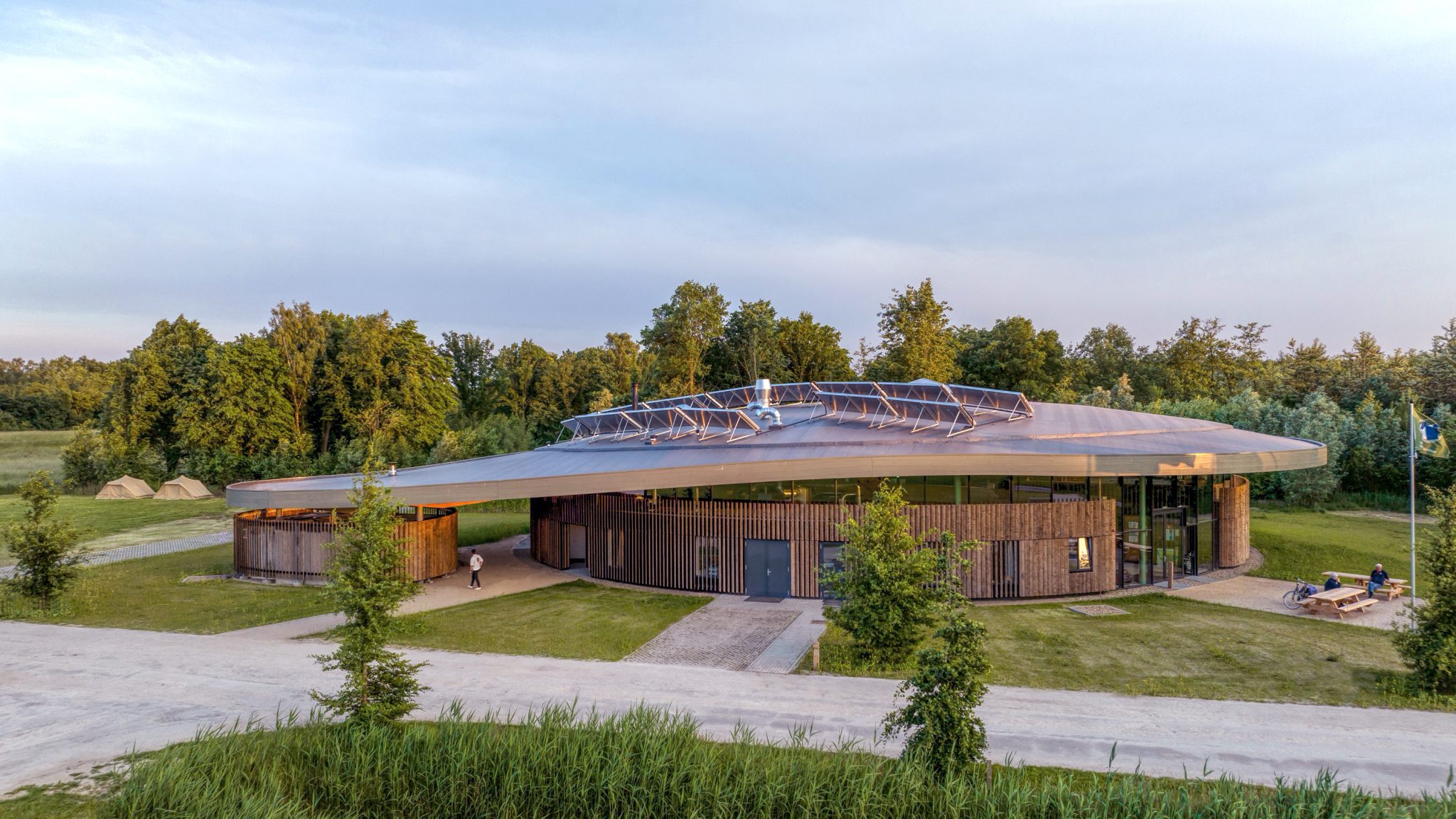 Curved roof elevation Avonturenhuis in the green natural surrounding designed and built by MOST Architecture