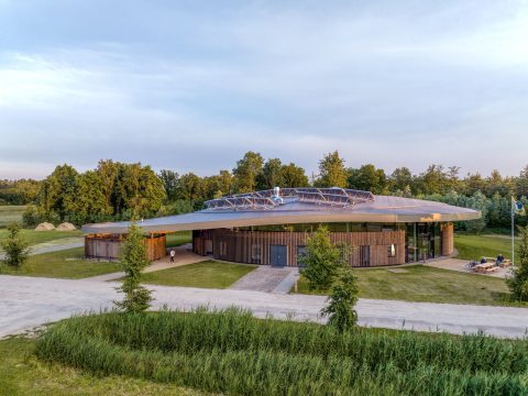 Curved roof elevation Avonturenhuis in the green natural surrounding designed and built by MOST Architecture