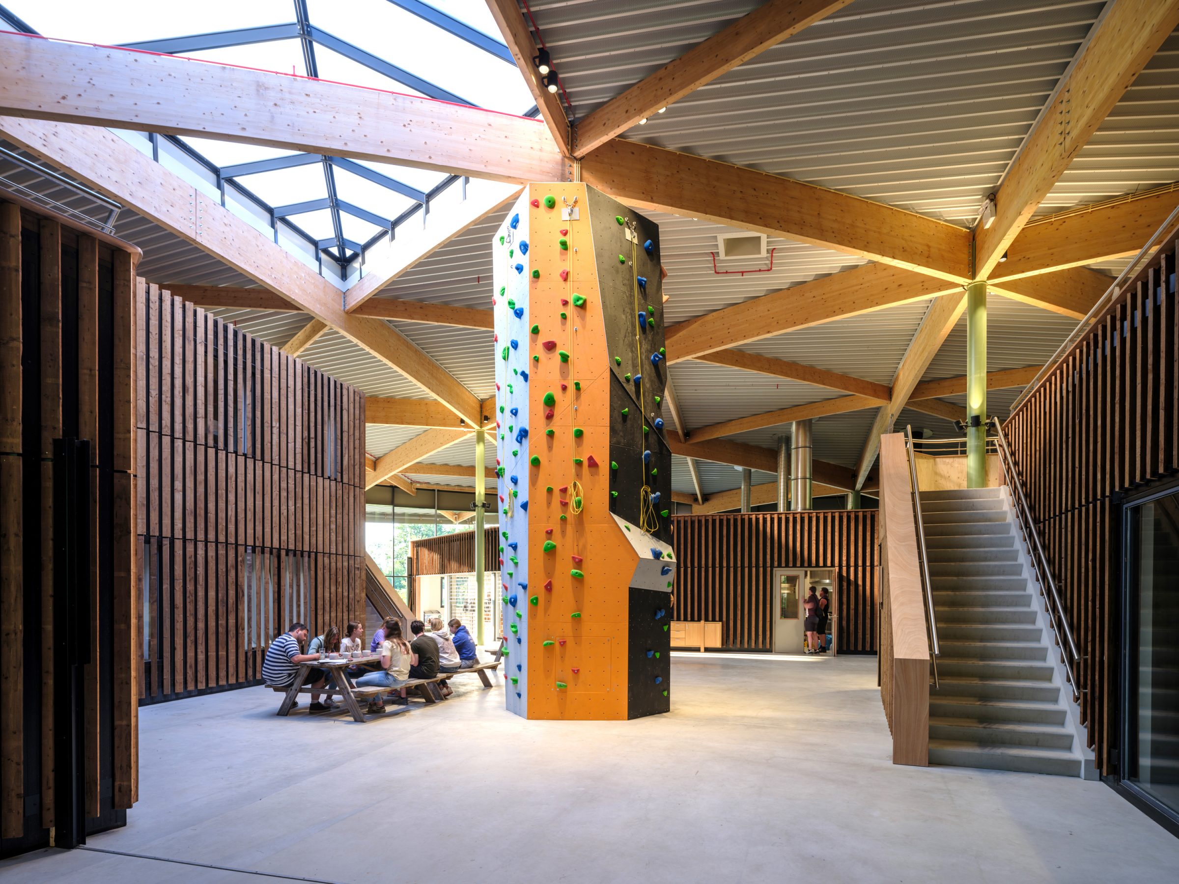 Interior space Avinturenhuis with climbing tower and wooden interior facade and laminated wooden curved beams designed and built by MOST Architecture