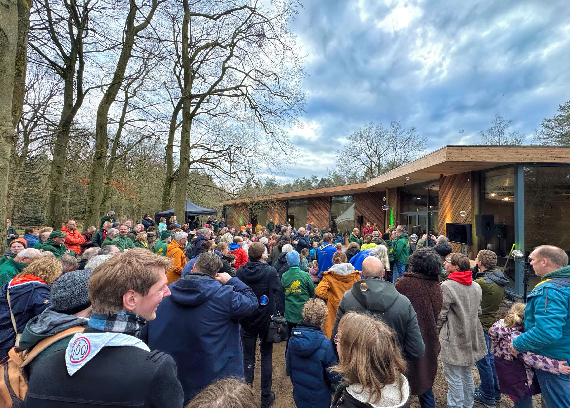 De feestelijke opening van de Beverburcht en Vleermuizengrot op Scoutcentrum Buitenzorg, met burgemeester Mark Röell en Thijs Jansen. De biobased, duurzame en rolstoeltoegankelijke accommodaties, ontworpen door MOST Architecture, Paul Geurts, bieden ruimte aan 80 gasten en combineren innovatieve bouwprincipes met scoutingtraditie en natuur